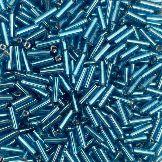 5gram Rocailles Bugles cyaan blauw - 6mm